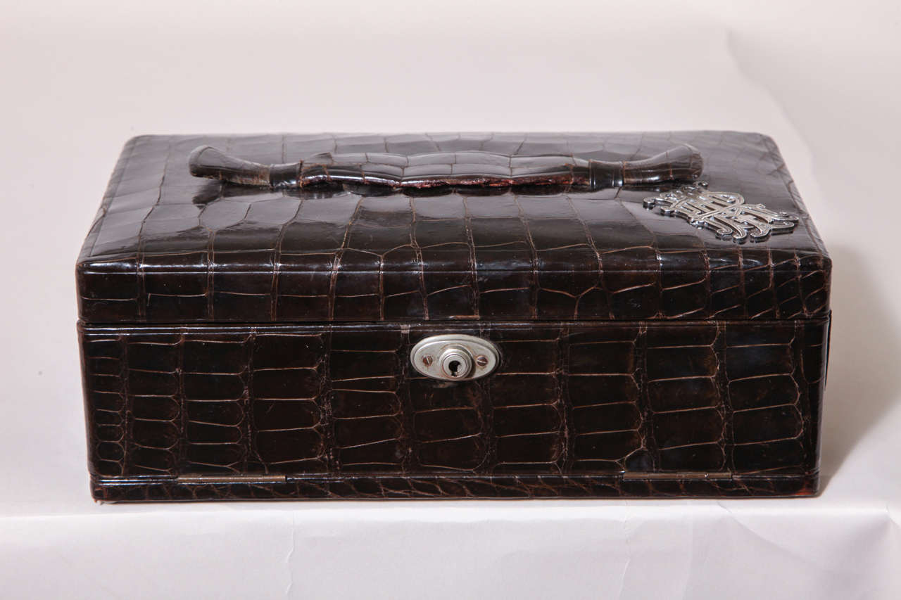 Alligator jewelry box with hinged interior and olive moire silk lining and wonderful silver monogram. With key and working lock.

Stamped R.W. Forsyth Ltd, Glasgow.

(Price shown is reduced price, no further trade discount) 