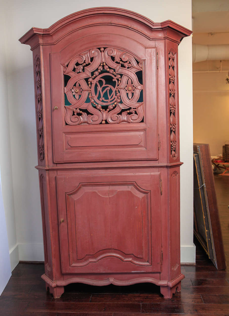 Red painted cabinet has two doors. Top cabinet has carved door and blue interior. Five shelves total. Hidden drawer between cabinet doors. New paint and some restoration additions. *Note: This cabinet has since been painted a very pale gray, so