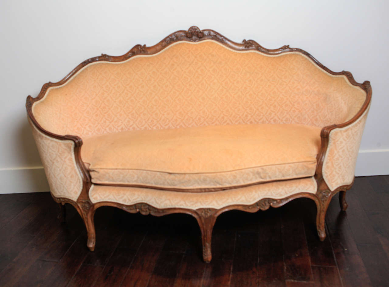 Carved frame sofa is upholstered in French gaufrage velvet.