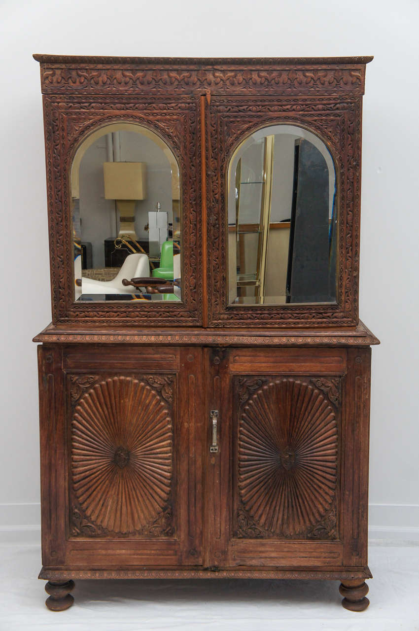 Beautiful vintage hand carved wooden cabinet.
Mirrors inside the doors as well as outside.
The interior shelves slide right out if you wanted to put a tv inside.
Great storage with with lots of charm.
My guess is it's from Bali.