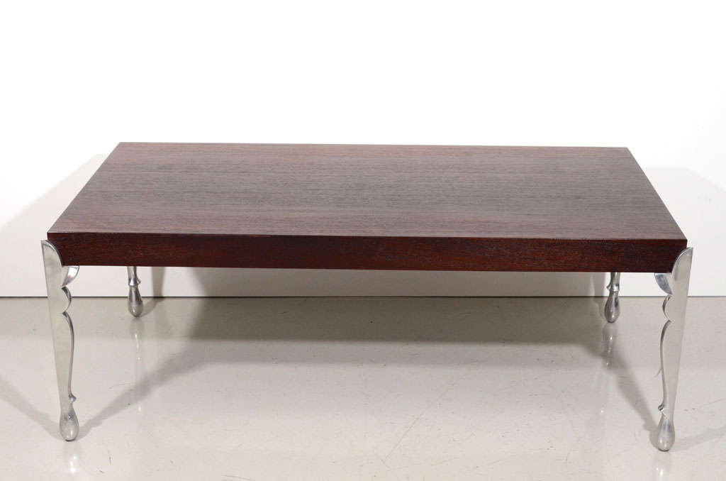 Dark, rich wenge wood is accented with ornate polished aluminum legs. Perfect height to use as a coffee table or add a cushion and use as a bench in a modern master suite.