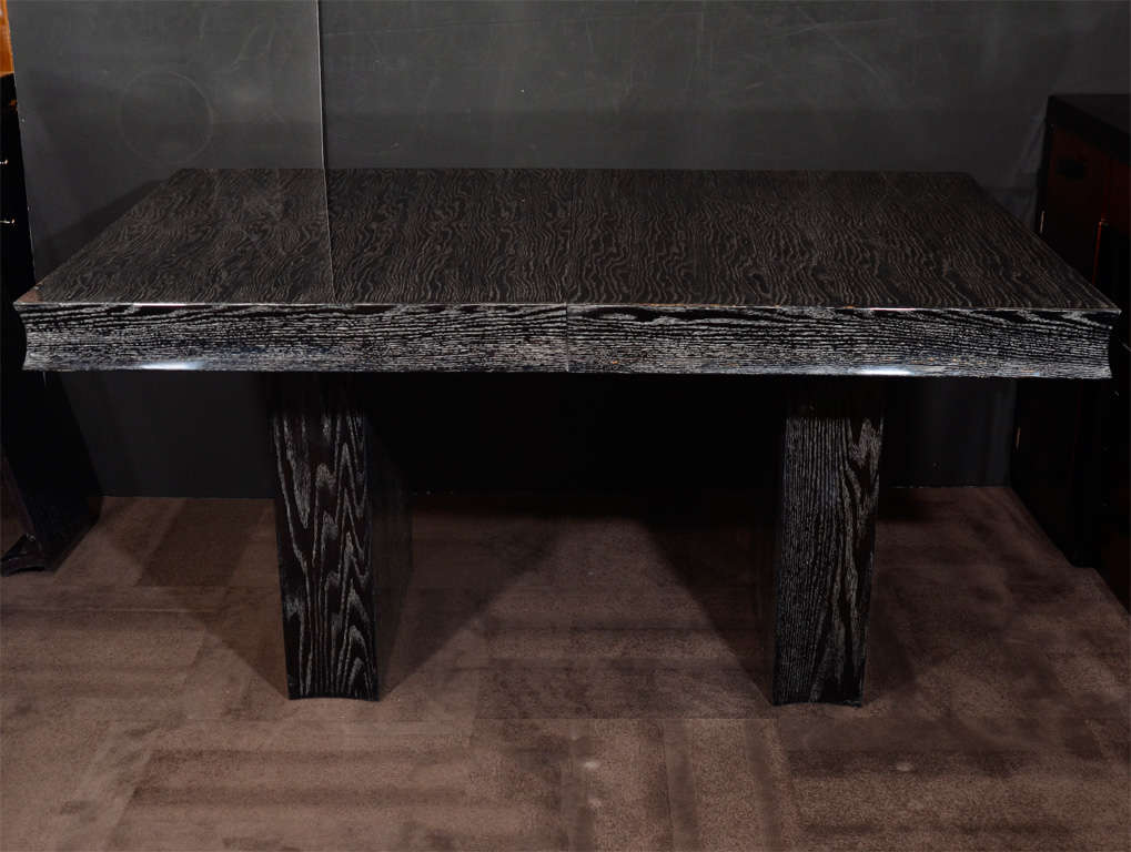 Exceptional modernist dining table in a beautiful silver cerused oak finish in hues of ebony with grains of silvered oak.  The table includes three - 10