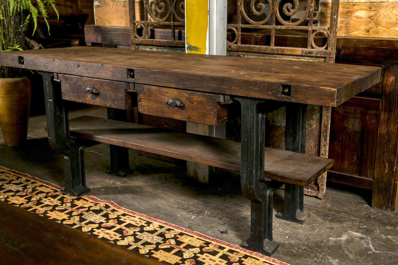 French cast iron base and beech top industrial work table, c. 1900-20, with 2 tool drawers and a fixed shelf below