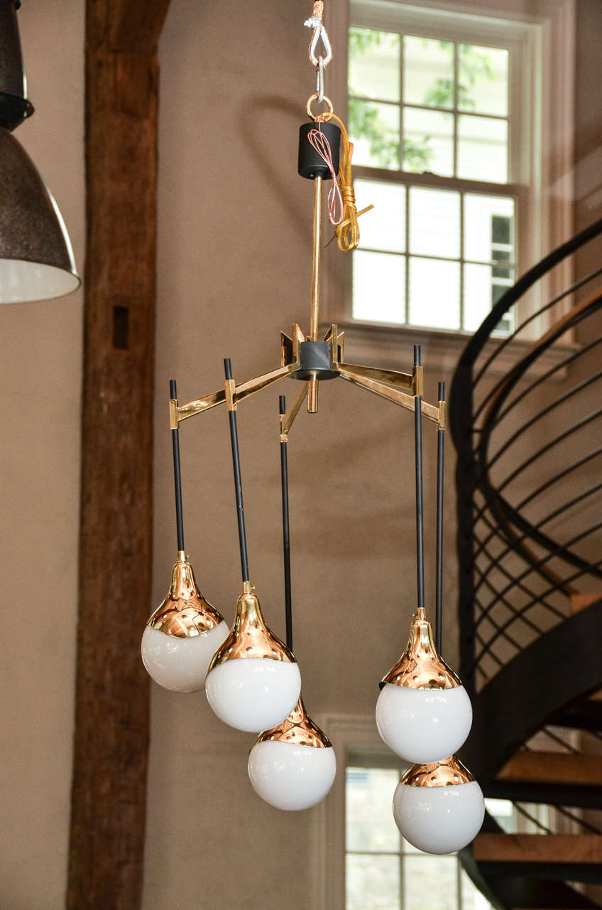 Stunning 1950s Italian chandelier with glass globes and brass detail in the style of Stilnovo.