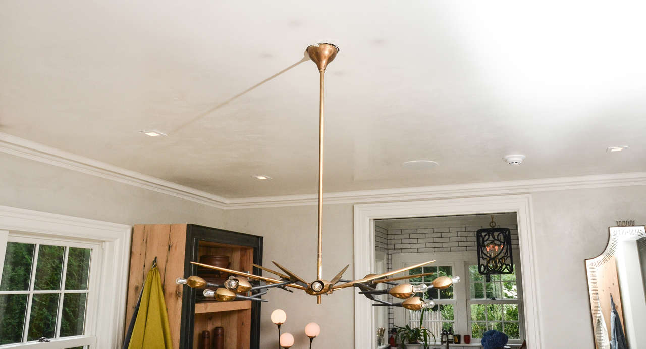 Beautifully crafted and futuristic 1960's Italian chandelier by Oscar Torlasco inblack metal with brass detail