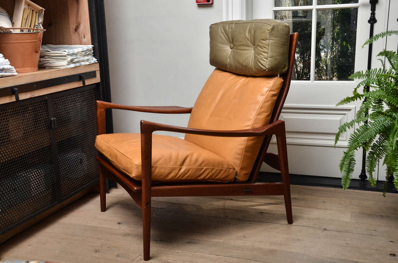 Solid teak frame with a curved high back, angled seat and high quality leather cushions make for an exceptionally comfortable seat. Designed by Danish-born architect and furniture designer IB Kofod-Larsen.

Ib Kofod-Larsen was a prominent figure in