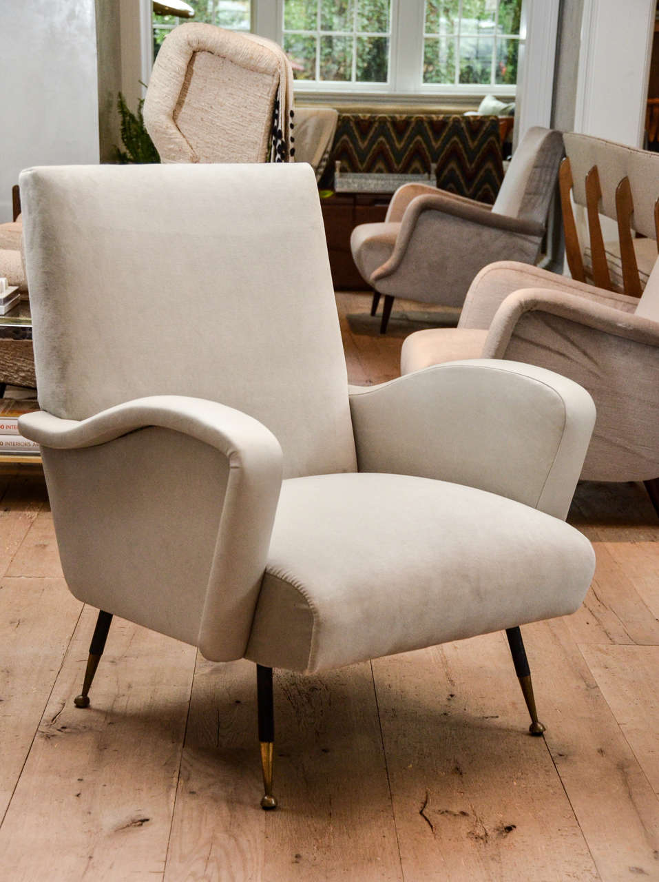 Beautiful pair of Italian Mid Century armchairs newly re-upholstered in grey velvet with leather armrest.
