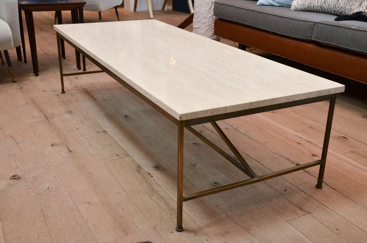 Stunning Mid-Century Paul McCobb coffee table with travertine top and brass legs.