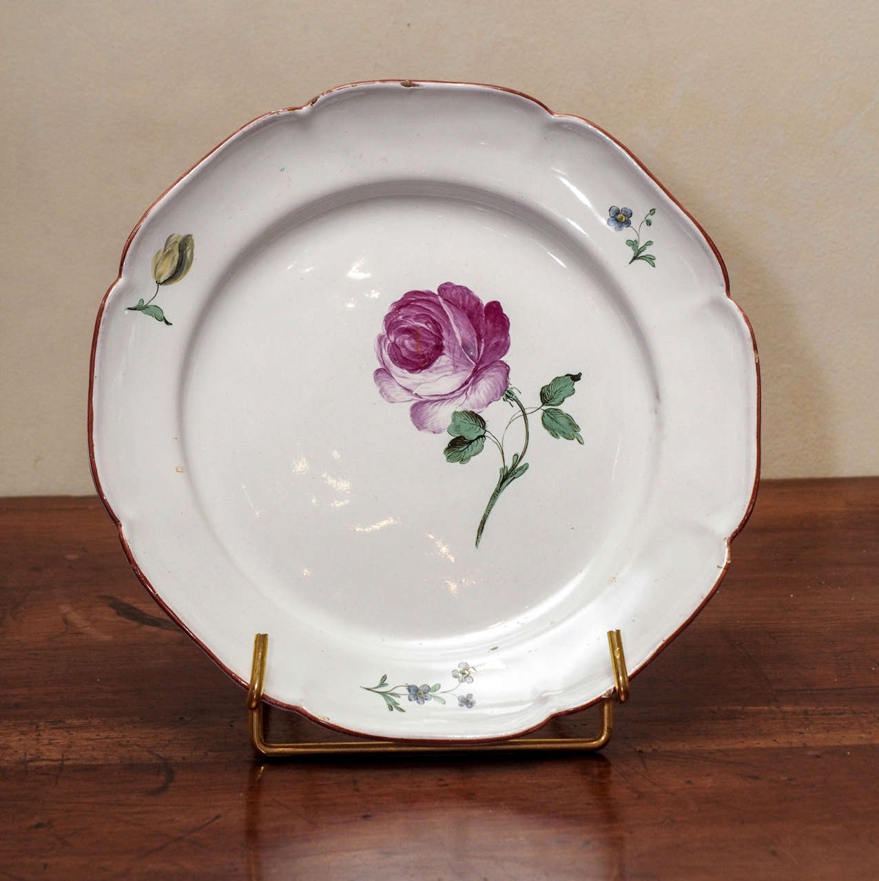 A Niderviller faience plate with rose. Niderviller is one of France's most famous faience manufacturers.