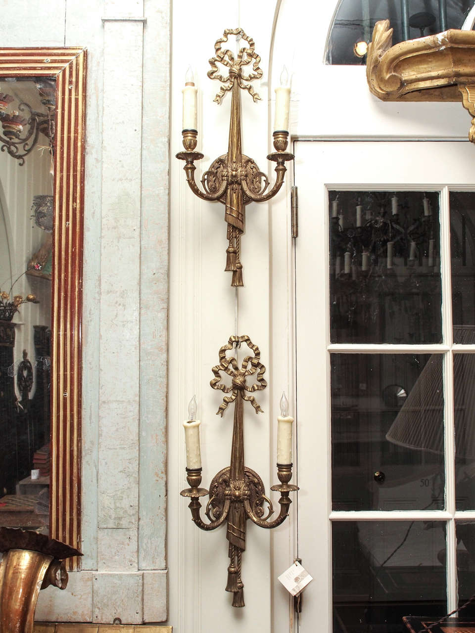 Set of four bronze two light wall sconces