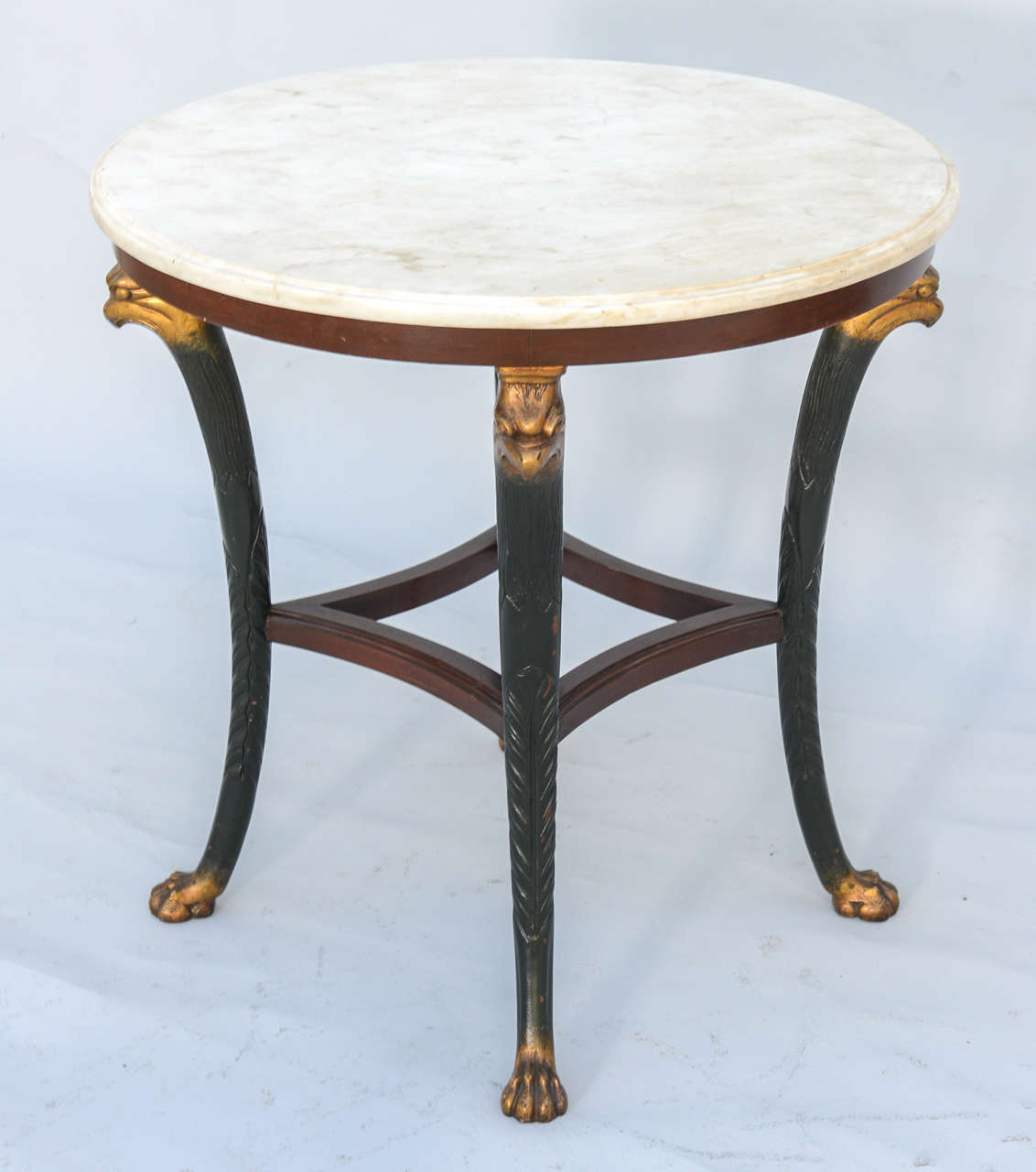 Round table, in Regency taste, having white veined marble top, raised on wood base, painted and parcel gilt; a carved eagle head atop each splayed leg, terminating in paw feet.

Stock ID: D6509