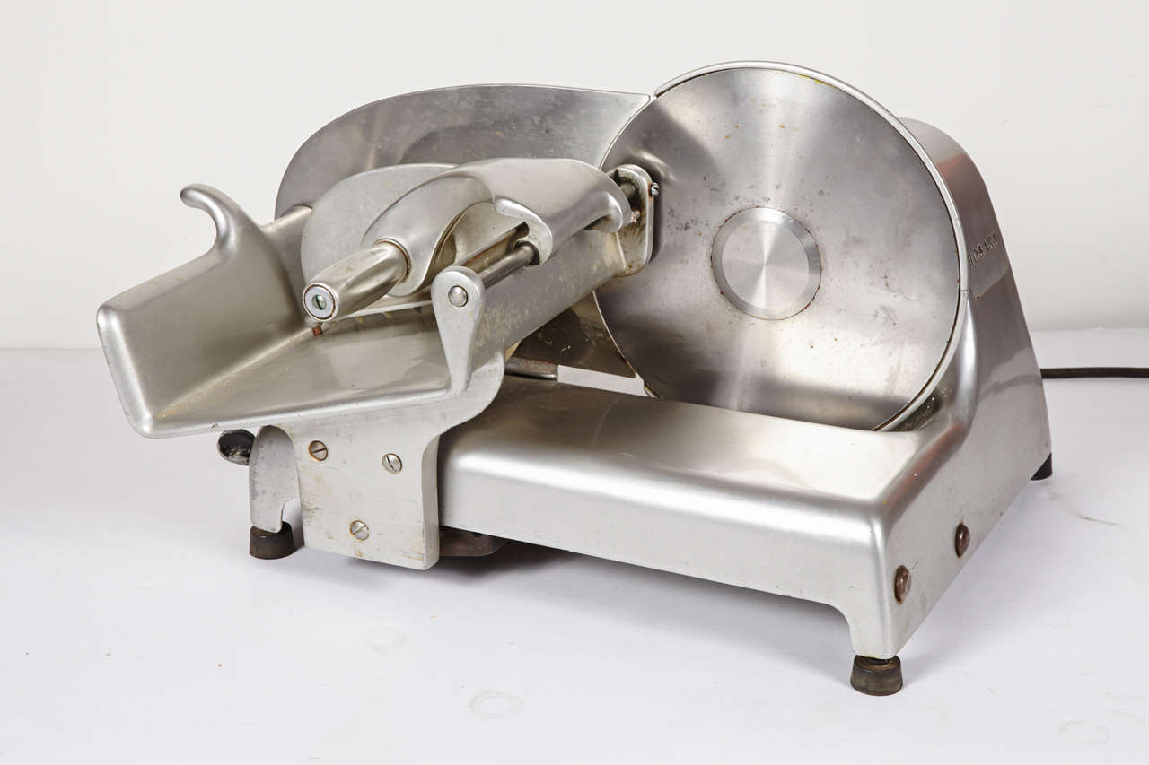 1943 patented design by Arens & Theodore Brookhart in original aluminum, steel and rubber configuration for Hobart Manufacturing Co. Troy, OH. Original incremented slicing meter on front. Complete with the relatively rare original spiked meat