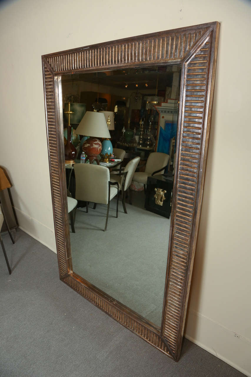 Beautiful full length beveled mirror by Nancy Corzine.
The massive carved on wooden frame has a silver pewter finish with a beautiful patina.
Of course it can be hung horizontally as well.