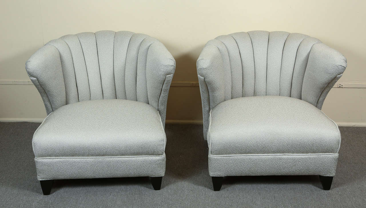 Pair of glamorous chairs with channel backs by James Mont. 
The chairs are newly reupholstered in a lovely silvery gray nubby fabric, and are 
on black tusk legs.