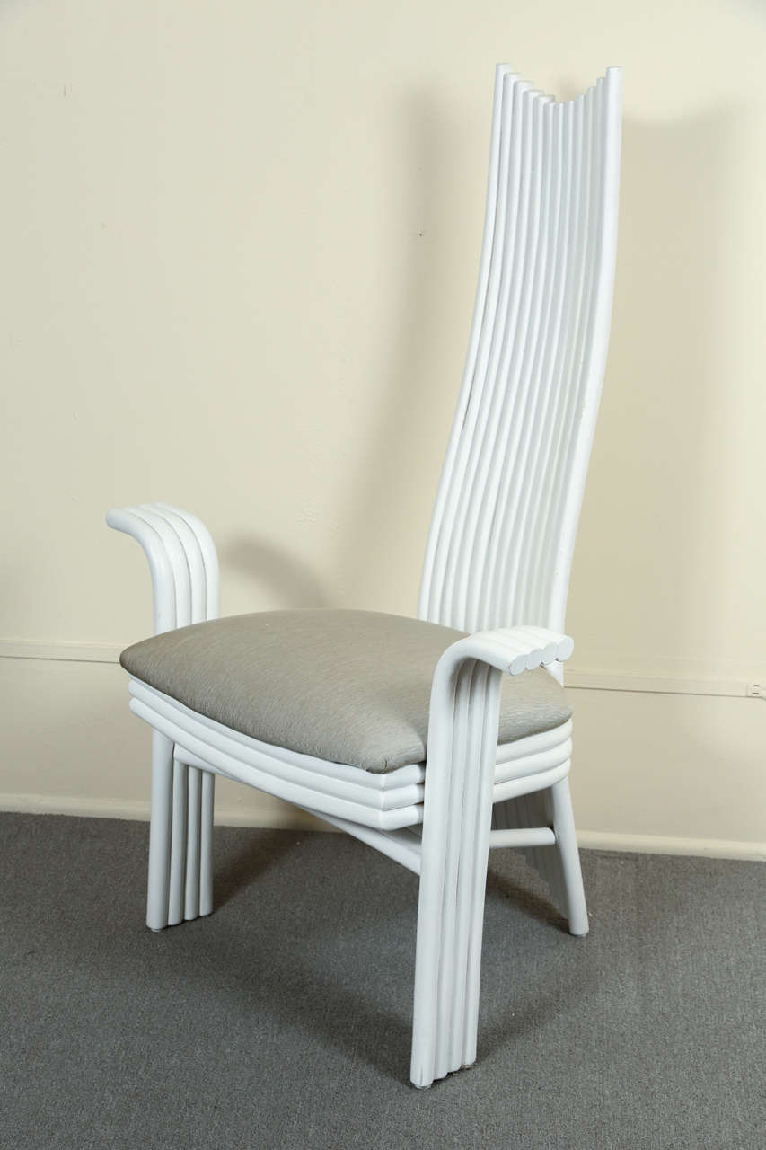 Six unusual high back dining chairs with arms.    The wood frames are made up of wooden curved dowels joined together.  They are painted white,  and the seats are newly reupholstered in a gray-beige fabric.