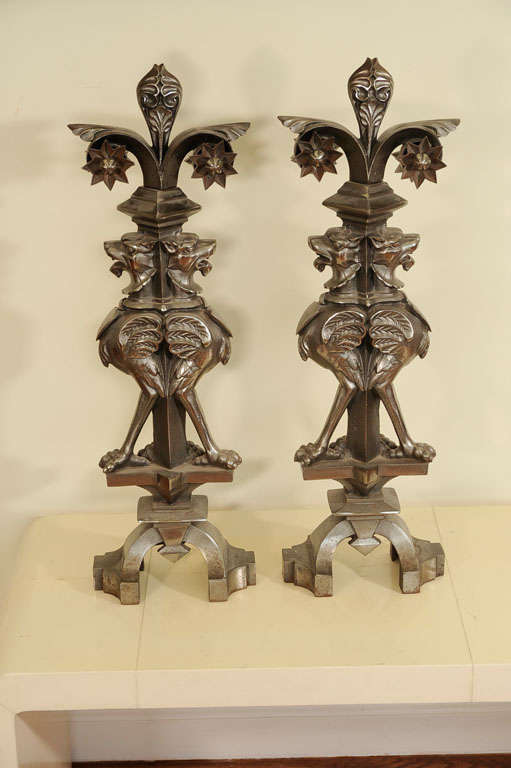 A pair of Gothic Revival architectural elements in solid steel each with a pair of gargoyles. Very heavy construction. Possible once newel post decorations. Can be adapted for use as andirons or firedogs.