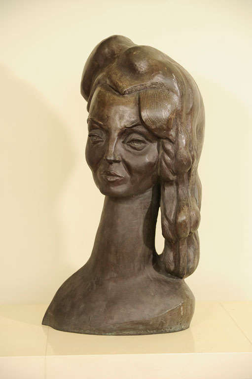 A fine solid bronze bust sculpture of a woman with an elongated next and stylized hair with a floral comb similar in feeling to the femme fatales of Tamara Lempika and self portraits of Frida Kahlo.

Very heavy solid casting signed E Nay.