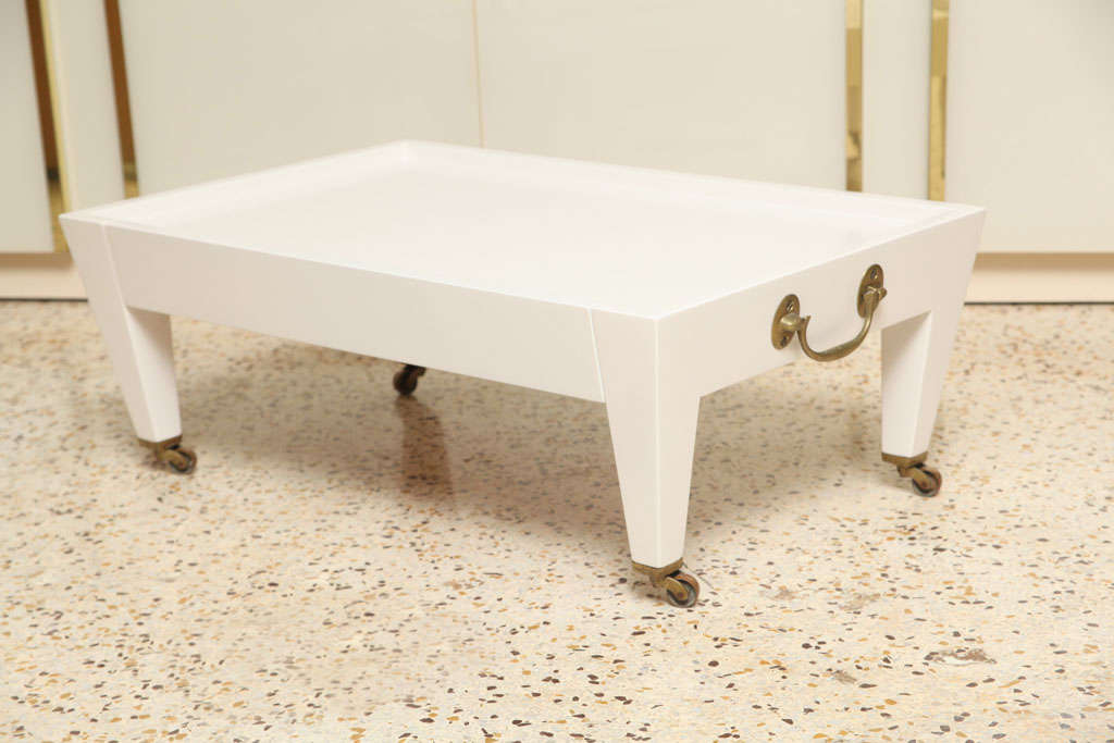 Chic, vintage low table by Angelo Donghia has an off-white satin finish, single pull-out drawer, un-polished, solid-brass casters and handles, and oodles of style!