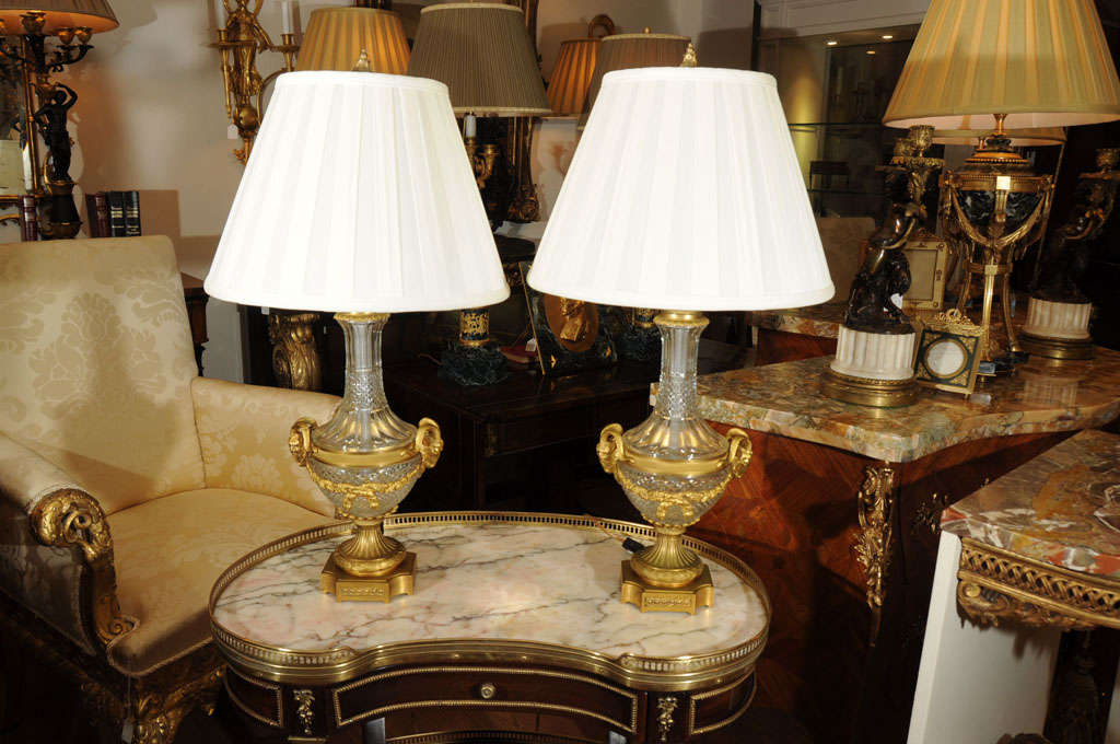Pr of 19th Century Louis XVI hand cut crystal lamps with rams heads and swag bronze dore details