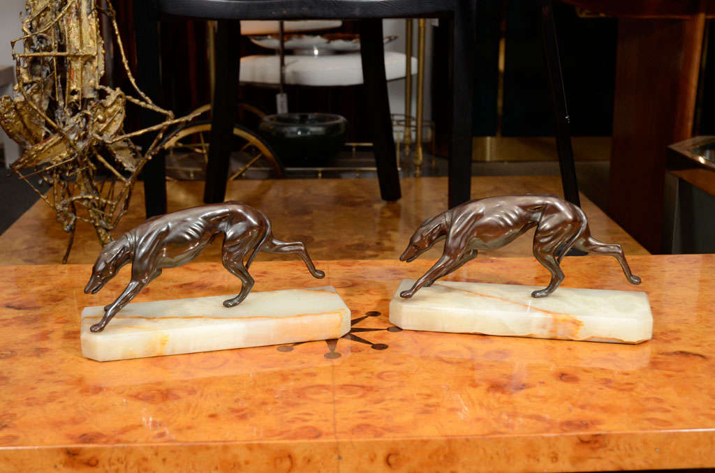 Pair of bronze greyhound bookends, mounted on alabaster base.  USA, circa 1940.<br />
<br />
Item may be viewed at the 1stdibs@NYDC showroom at the New York Design Center, 200 Lexington, 10th Floor, New York, NY, 10016.  For phone orders, please