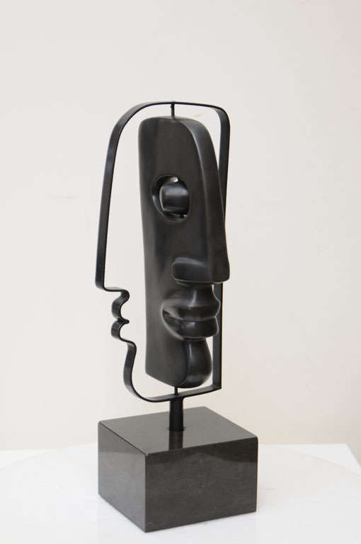 This amazing heavy solid cast bronze table top sculpture pivots on it's pins... hence being a mobile head and the eye becomes a
movable object. it is Picasso meets Picasso's influence of African art. it is a very small edition ,signed by the