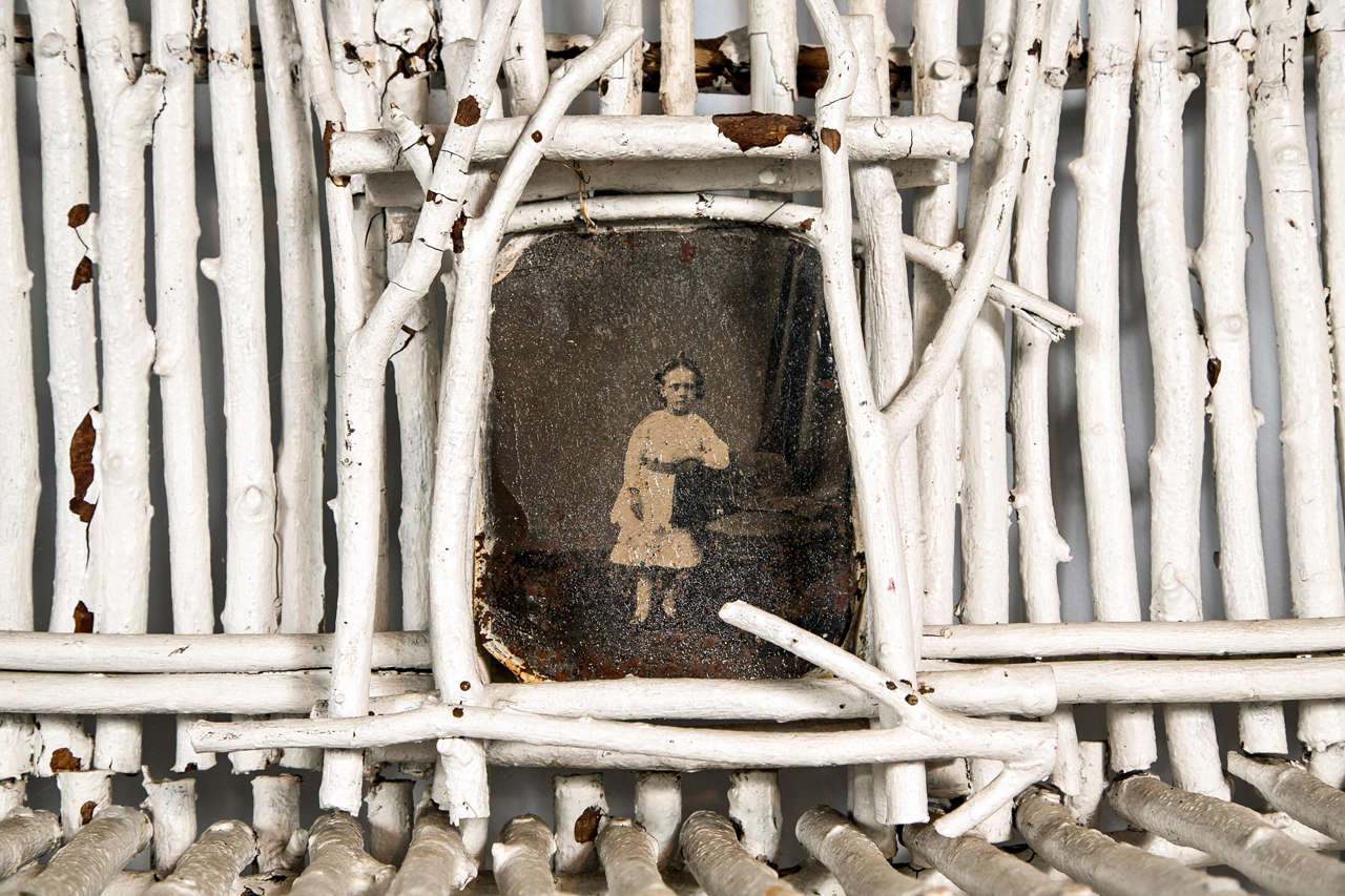 Found in the Berkshires, this etagere was made by a local craftsman in the 1960s.  The tin-type of the little girl at the top is 19th century.  The paint is original, and the effect is at once haunting and lyrical.