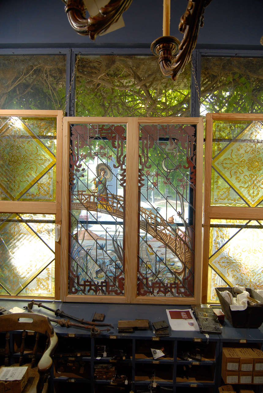 Pair of early 20th century Art Nouveau windows with oriental motif.  Made by the well known stained glass artist, Lux Fournier, and the atelier Fournier, which was established by his father in Tours, France.  The pair of panels is signed and dated