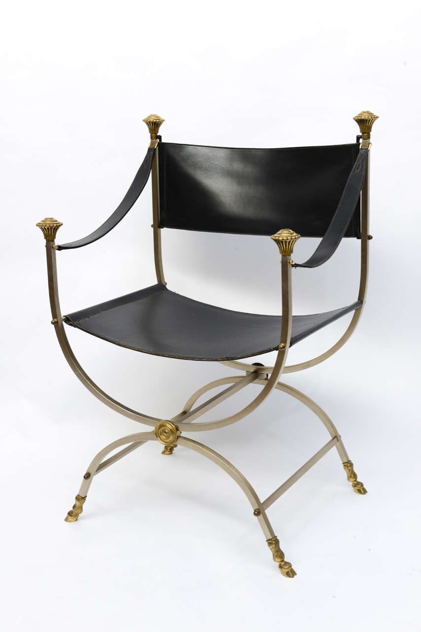 Stunning pair of stainless steel and brass framed black leather Savonarola chairs.  Beautifully accented with hoofed feet, knobs and medallions.