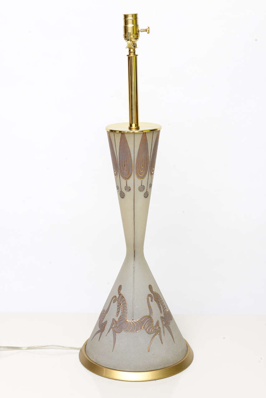 Waylande Gregory would certainly claim this elegantly humorous and playful style of this exquisite tall blown textured glass, gilt and bronze enameled hourglass shaped table lamp has four magical large gilt zebras around its body with festoons