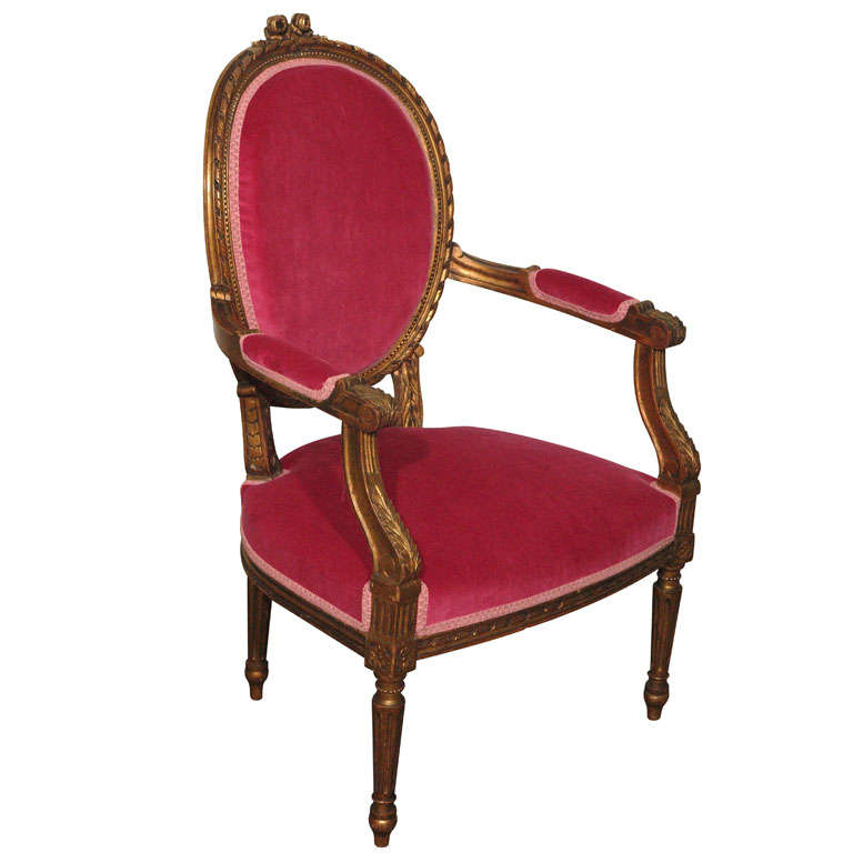 This French Louis XVI style giltwood armchair is probably one of my favorite pieces ever as it can completely add instant drama to any room with its rich, vibrant fuschia (fuchsia) and gold color.  The gold hand-carved wood frame has a deep and rich