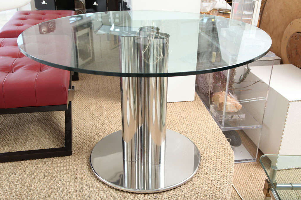 Sleek ultra modern table designed in the early 70's by one of Italy's most talented Designers. This fashionable dinning table incorporates several elements that boosts its overall design, such as the chrome pillars that are precisely placed to