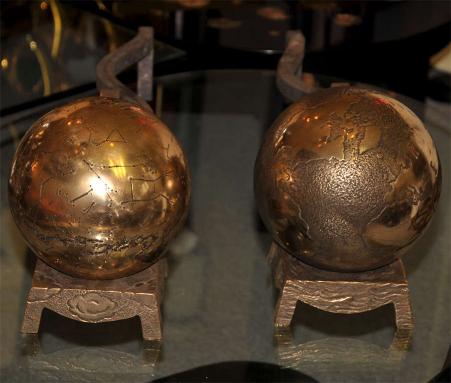 Two 1970s andirons in patinated bronze, with one terrestrial and one celestial globe with zodiac signs. Signed by Van Heeck.