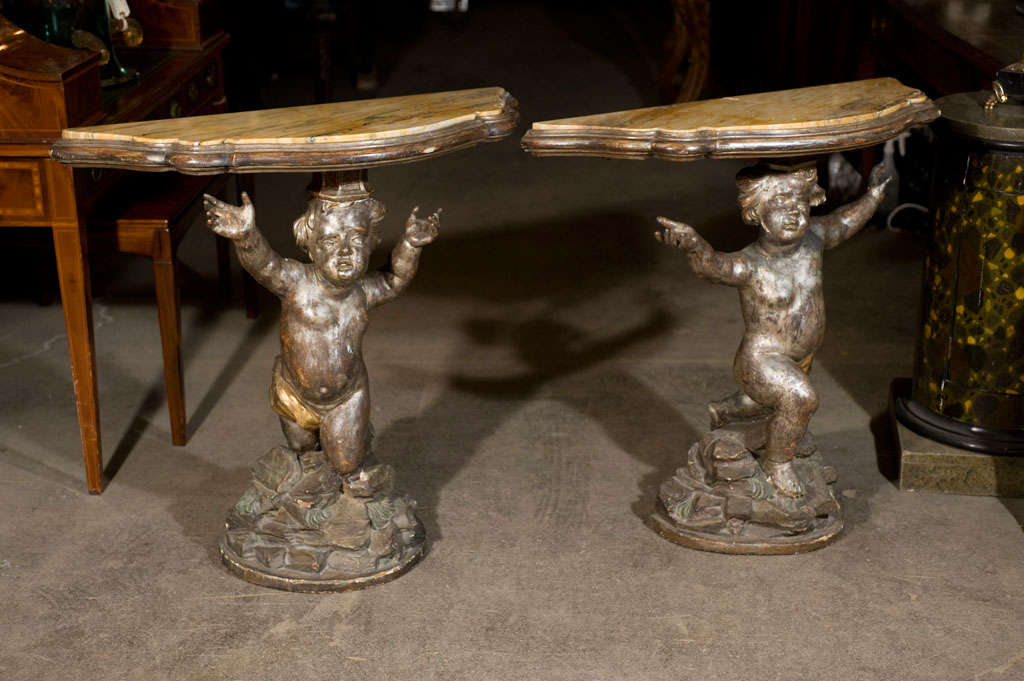 Fantastic quality pair of Venetian consoles of carved silver leaf pine. Sienna marble tops.