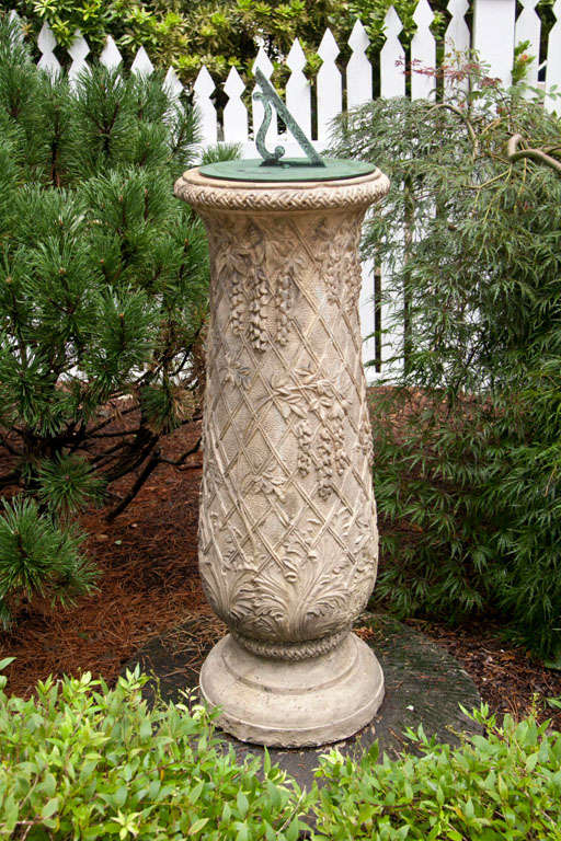 A terra-cotta sundial pedestal, the baluster decorated with latticework and wisteria vines, with acanthus leaf motif and braided motif at rim, attributed to M. H. Blanchard, English, ca. 1860, with associated bronze sundial plate marked “D. Davis