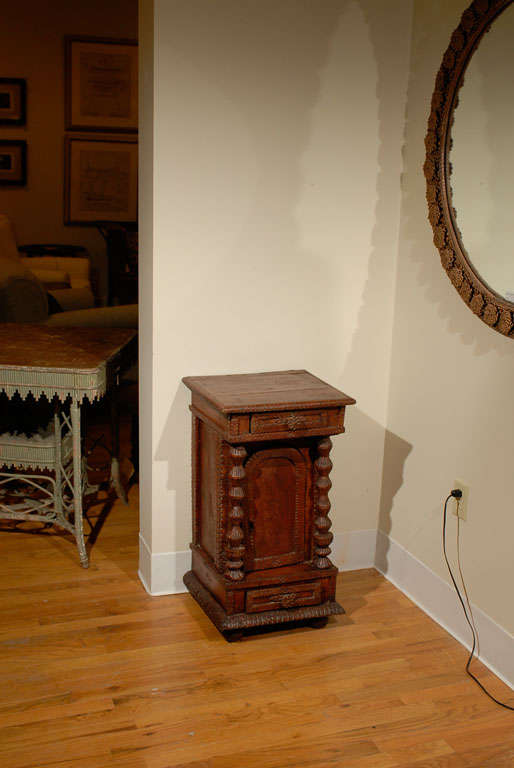 This is a wonderful little French cupboard.  Art Populaire is French folk art.  This cupboard is in original deep brown-red paint.  The details are fantastic.  The trim, columns, 2 drawers, arched door, and even the side trim is wonderfully carved. 