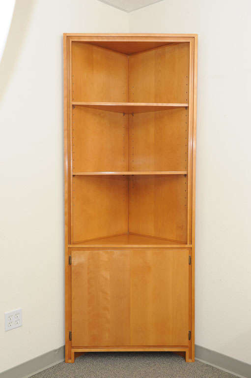Russel Wright Maple corner cabinet manufactured by Conant Ball, excellent original finish. Top cabinet has two adjustable shelves. Bottom cabinet is 25'' tall, with one shelf.