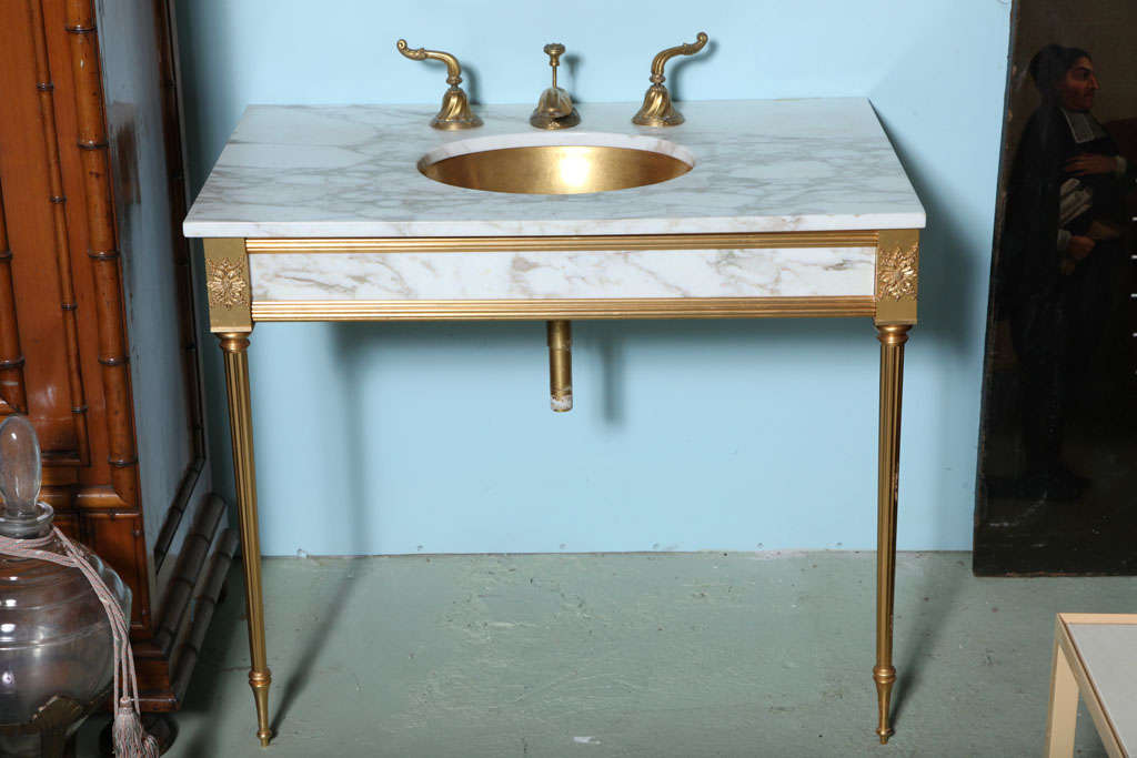 Included white marble @ 22k gold plated vanity on two gold fluted tapered legs,22k gold plated sink,22k plated faucet set,22k gold plate mirror medicine cabinet with three glass shelves inside,and a rare gold plated,white glass wall light-all from a