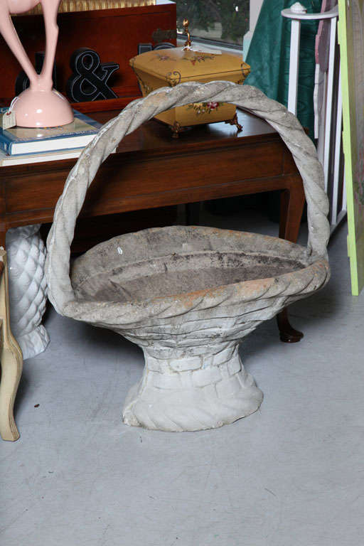 Very lovely composite stone basket with rope handle.