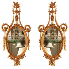 Pair of Carved Giltwood Classical Oval Mirrors