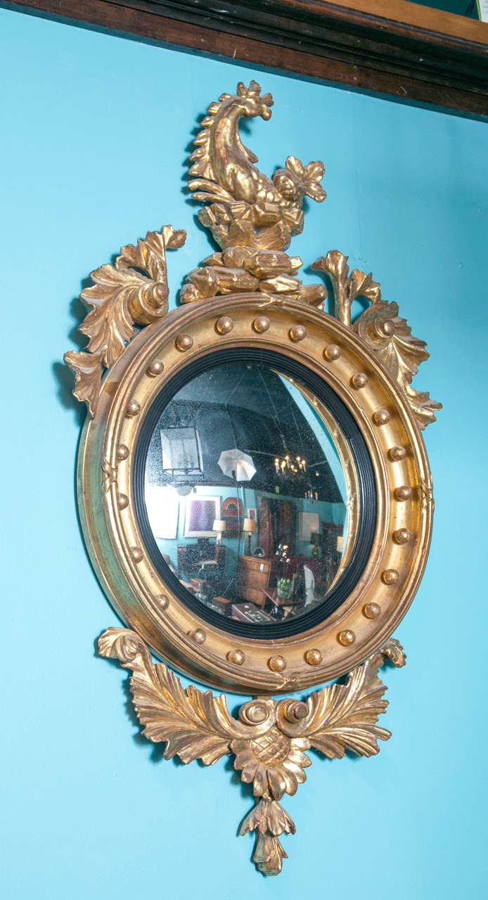 American Federal Convex Mirror gilded wood, with carved wood equestrian motif and foliage original glass with reeded ebonized edge