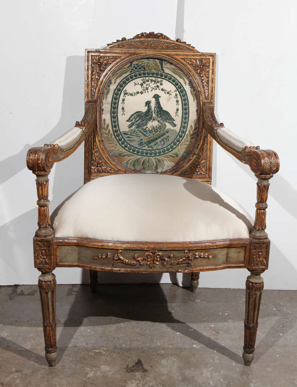Richly carved, hand-painted, parcel-gilt, Louis XVI armchair with beautiful, 1800s fabric medallion on the splat.