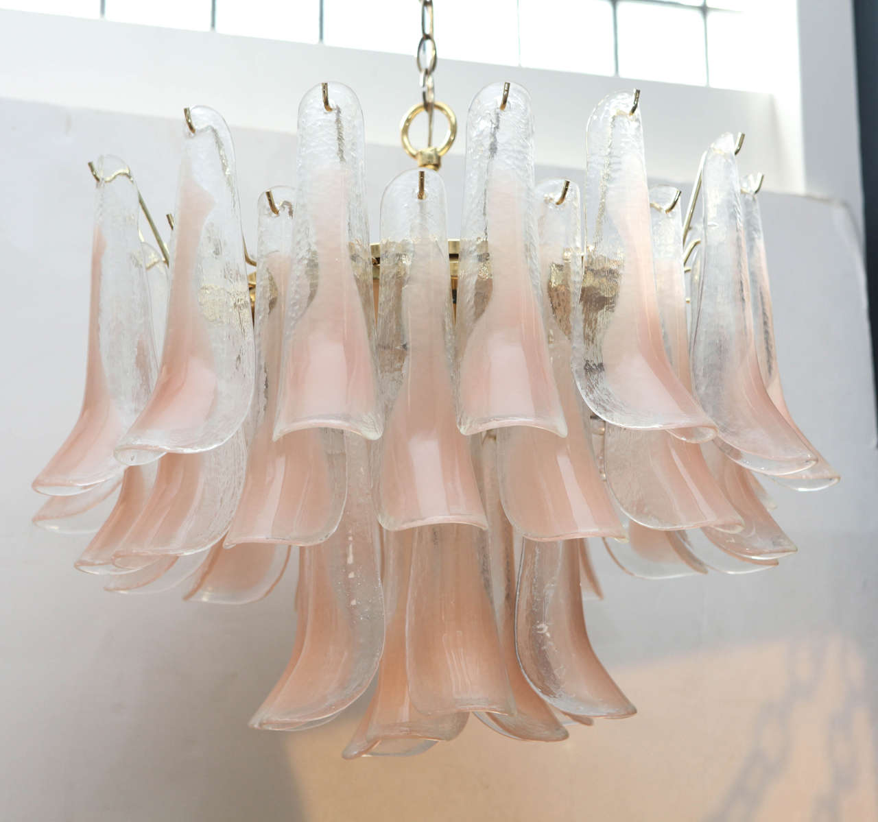 Brass fixture hung adorned with three tiers of handblown pink petal Murano glass.