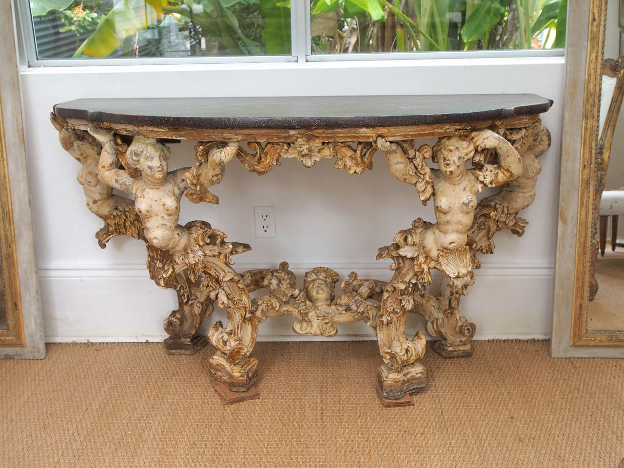 Very carved, some gilt and paint
top is painted wood
