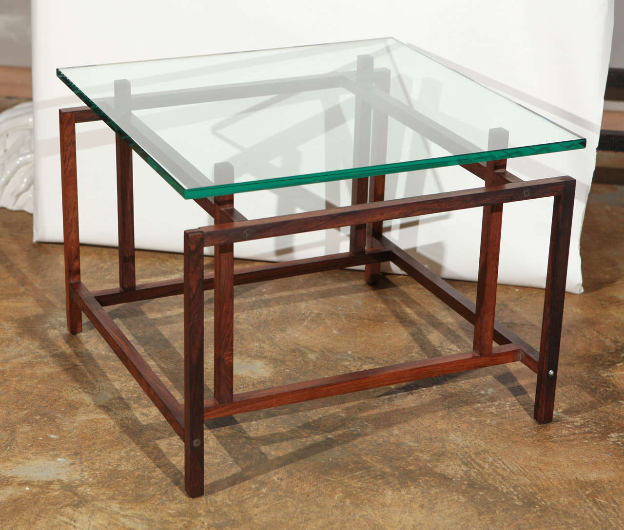 Mid-Century Danish Rosewood side table by Henning Norgaard for Komfort, Denmark. New glass. There are no pegs that the glass sits on. The glass sits directly on the top as shown. 
