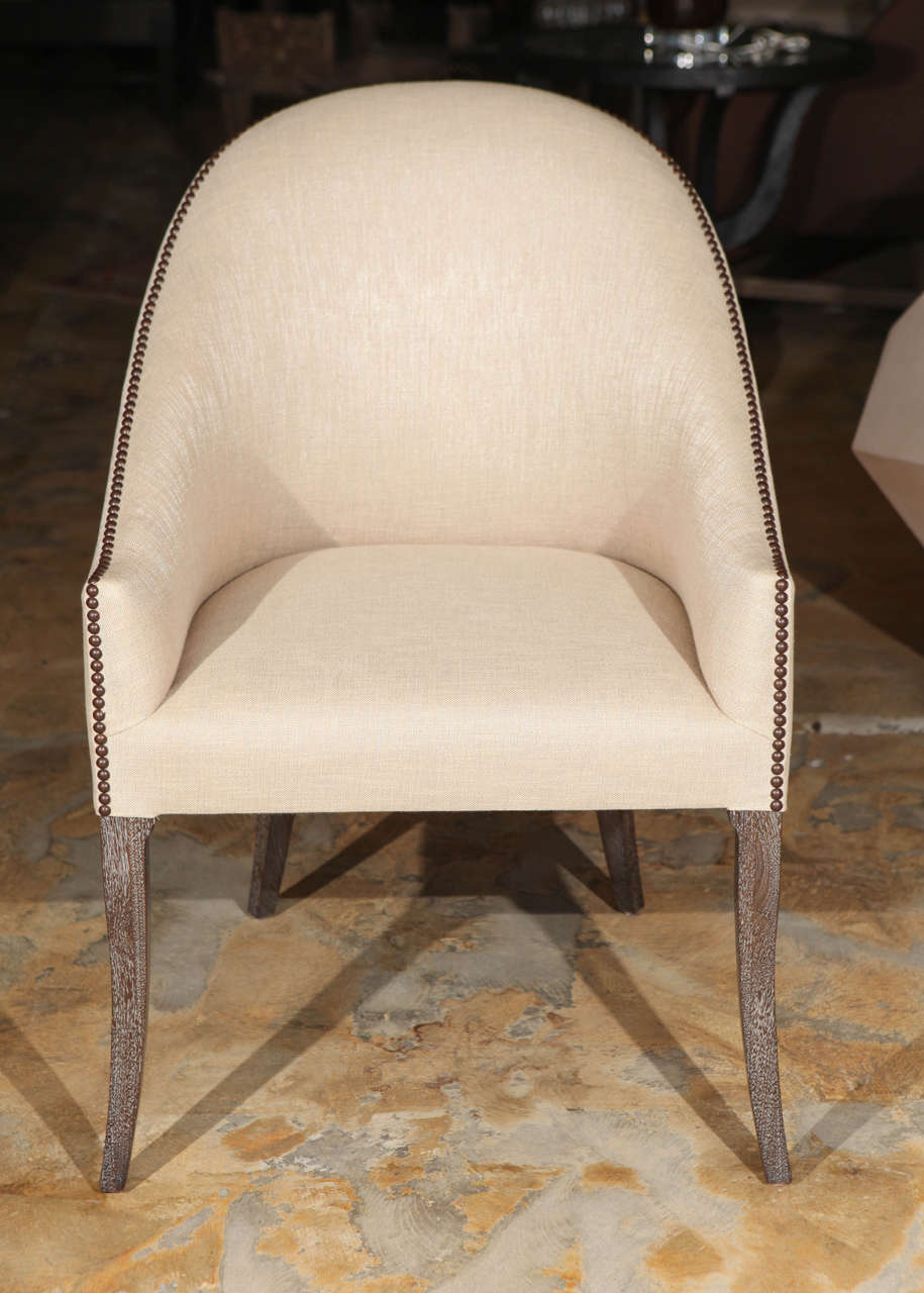 Club or occasional chairs, spoon back design with linen upholstery. Main image shown as a pair, pricing is per each. By order. Nailhead in oil rubbed bronze color, new linen upholstery, new ceruse walnut finished legs. Seat 19.5 D, 18.5 W.  Order