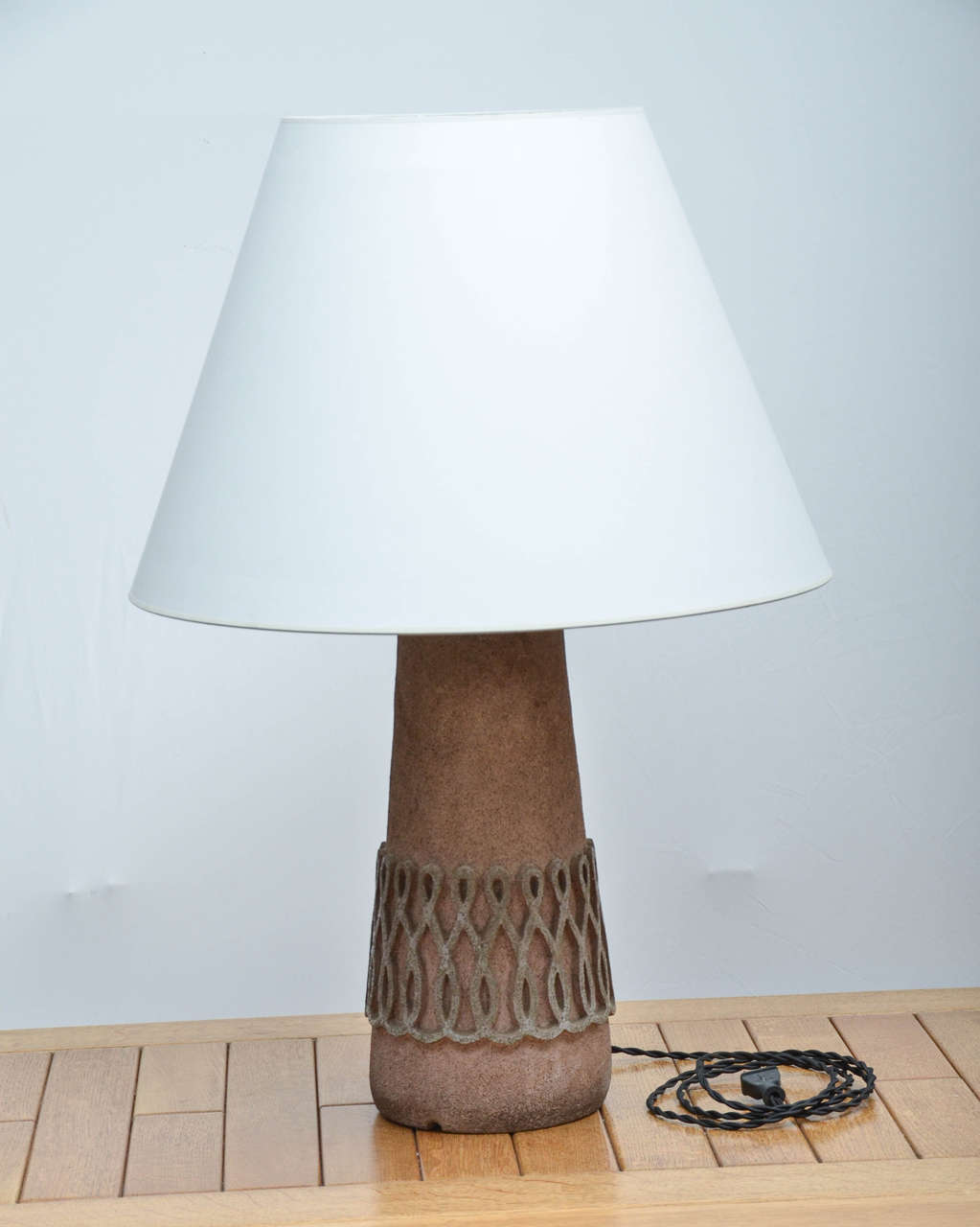 Stone Table Lamp, with natural tan/beige body and intricate design painted in a soft grey color. Base is heavy. Newly rewired with black twisted silk cord, bronze fittings. Shade is not included.