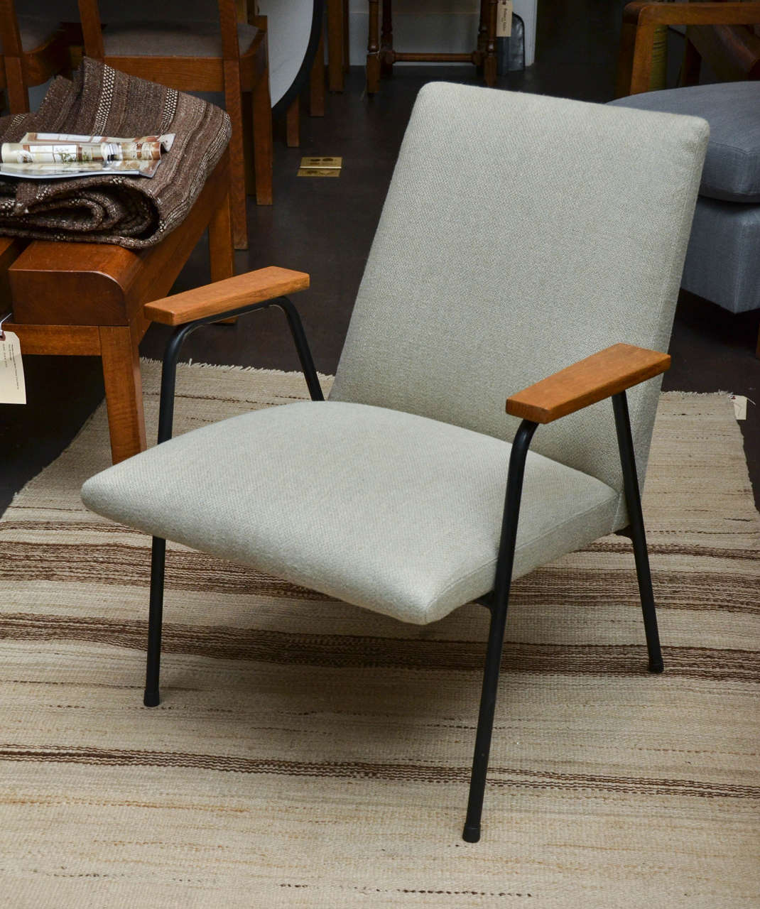 Mid-Century Upholstered Metal Armchair in the Manner of Prouve, France, c. 1950s

Sleek design consists of a clean tubular metal frame, handsome wooden armrests, and brand new upholstery in a natural linen with pale blue thread integrated into the