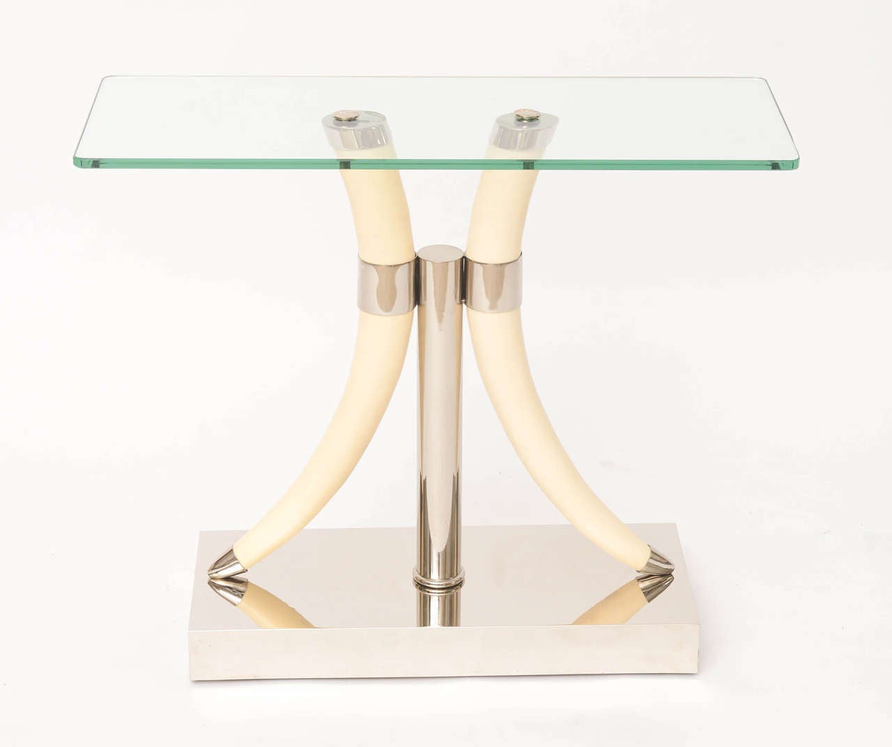 Elegant 1970s nickeled side table with resin tusk supports and glass top.