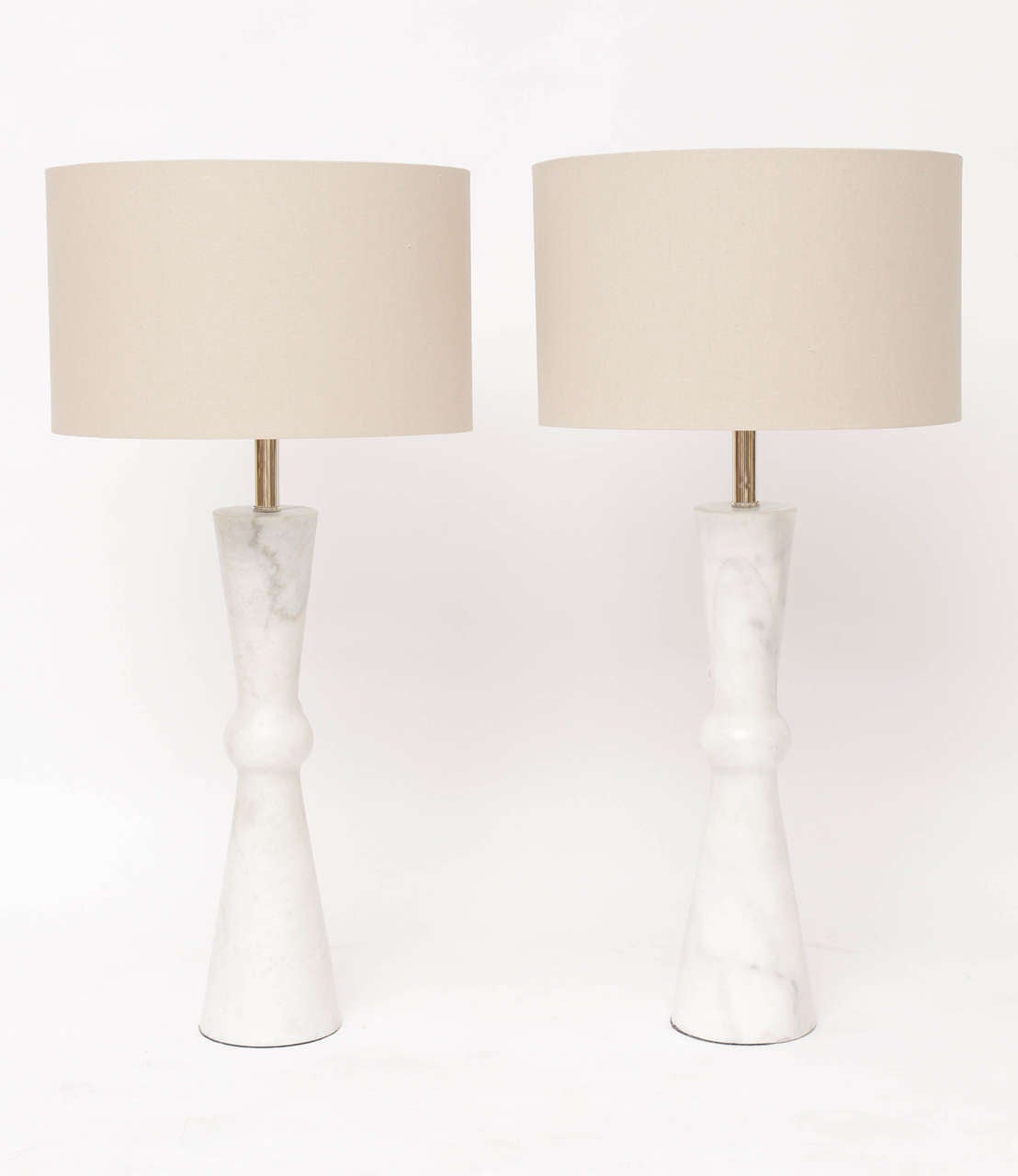 Elegant and tall pair of hand-carved, carrera marble Modernist table lamps, circa 1960. European style braided silk wiring enters through the neck of the lamp. Nickel hardware, newly re-wired. (Shades not included.) Height measurement below is to