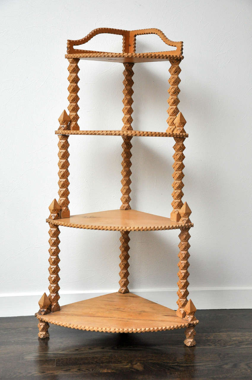 This pine corner shelf has hand-carved details on the edges and stiles.